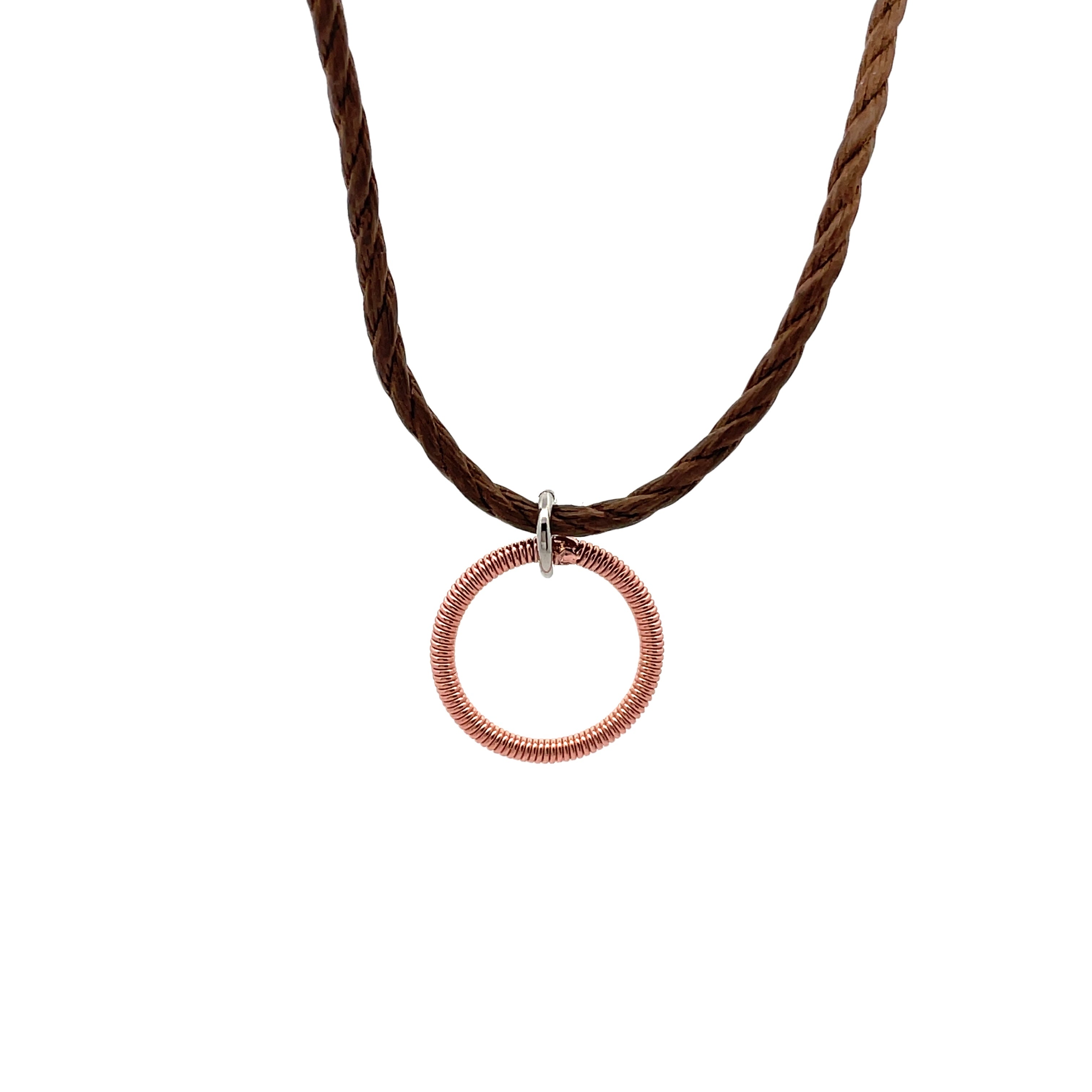 piano string circle pendant on brown cord on white background