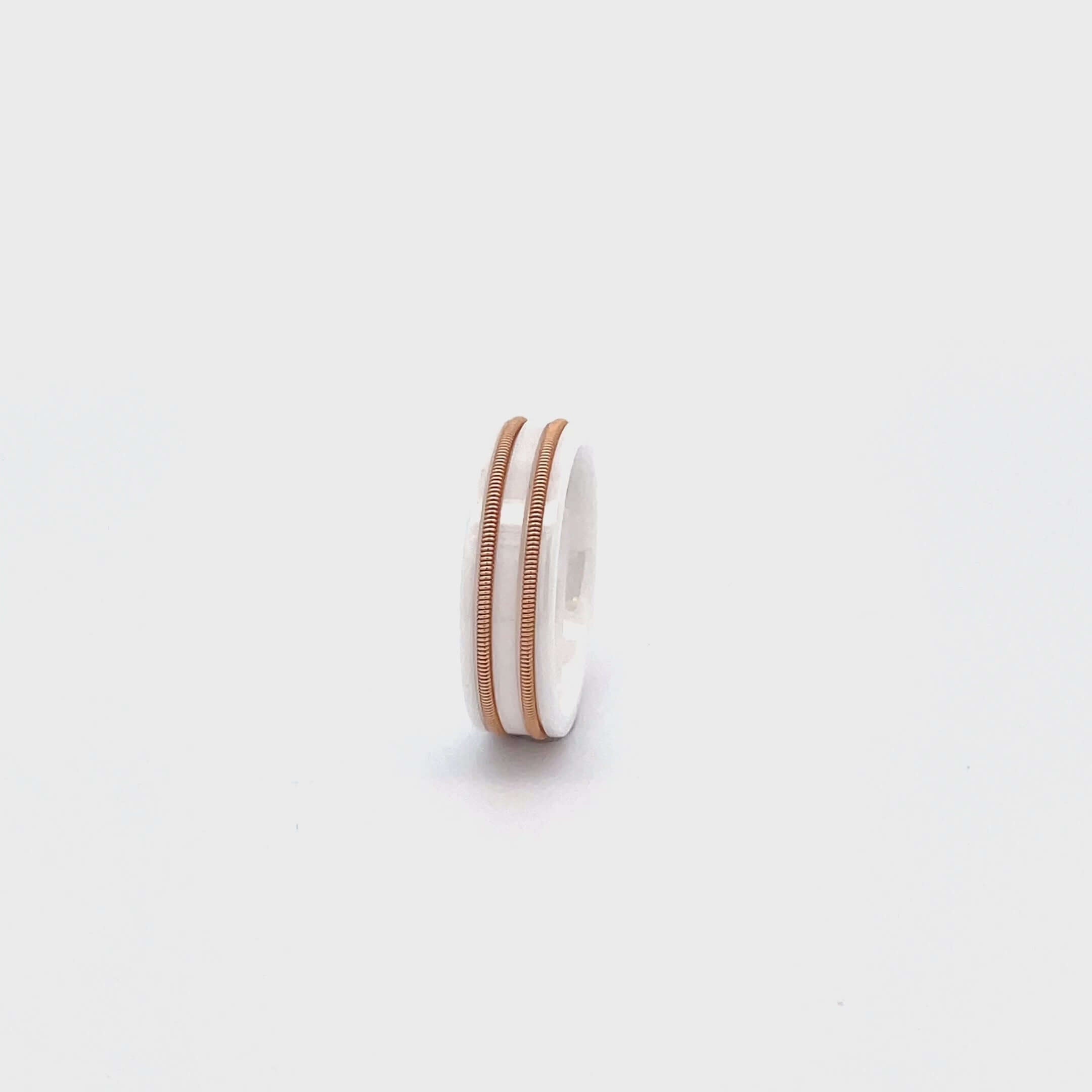 white guitar string ring rotating on white surface