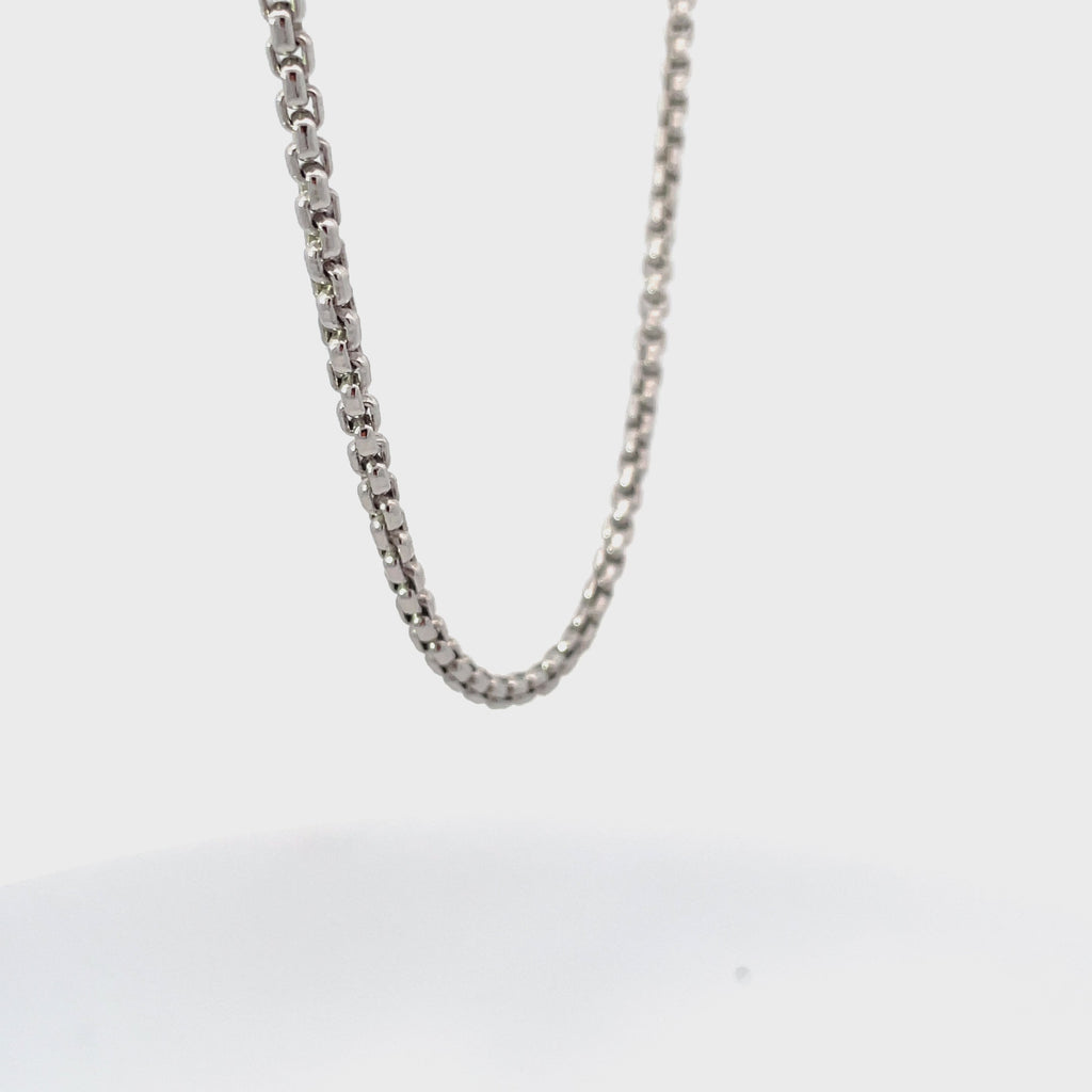 Silver round box chain rotating on white background.