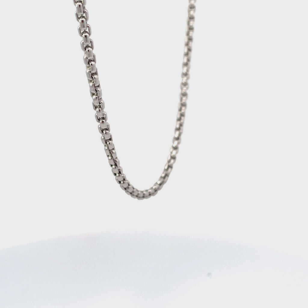 Silver round box chain rotating on white background.