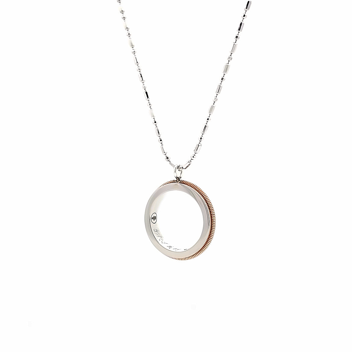 guitar string and sterling silver round pendant on a rose gold chain