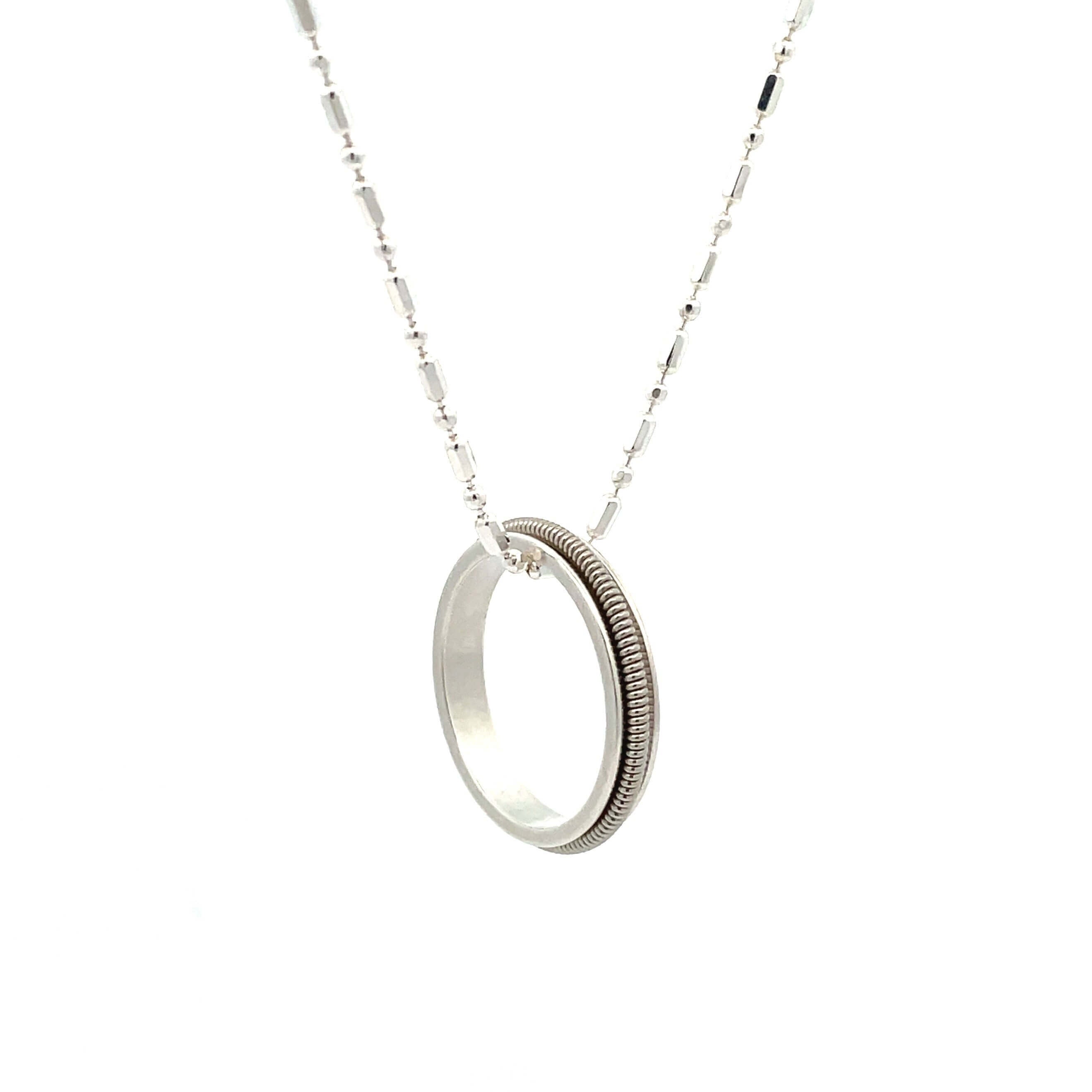 electric guitar string ring necklace on white background