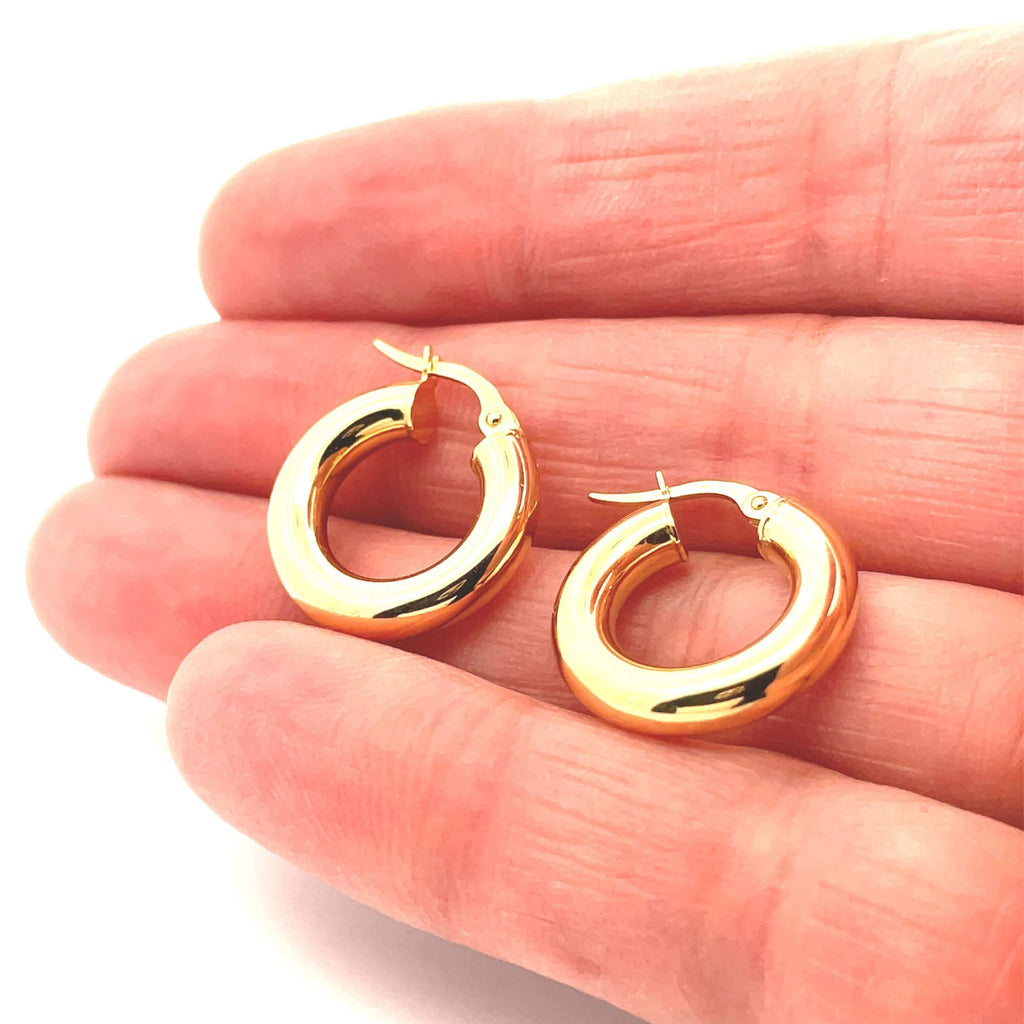 small thick 10K gold hoop earrings on hand
