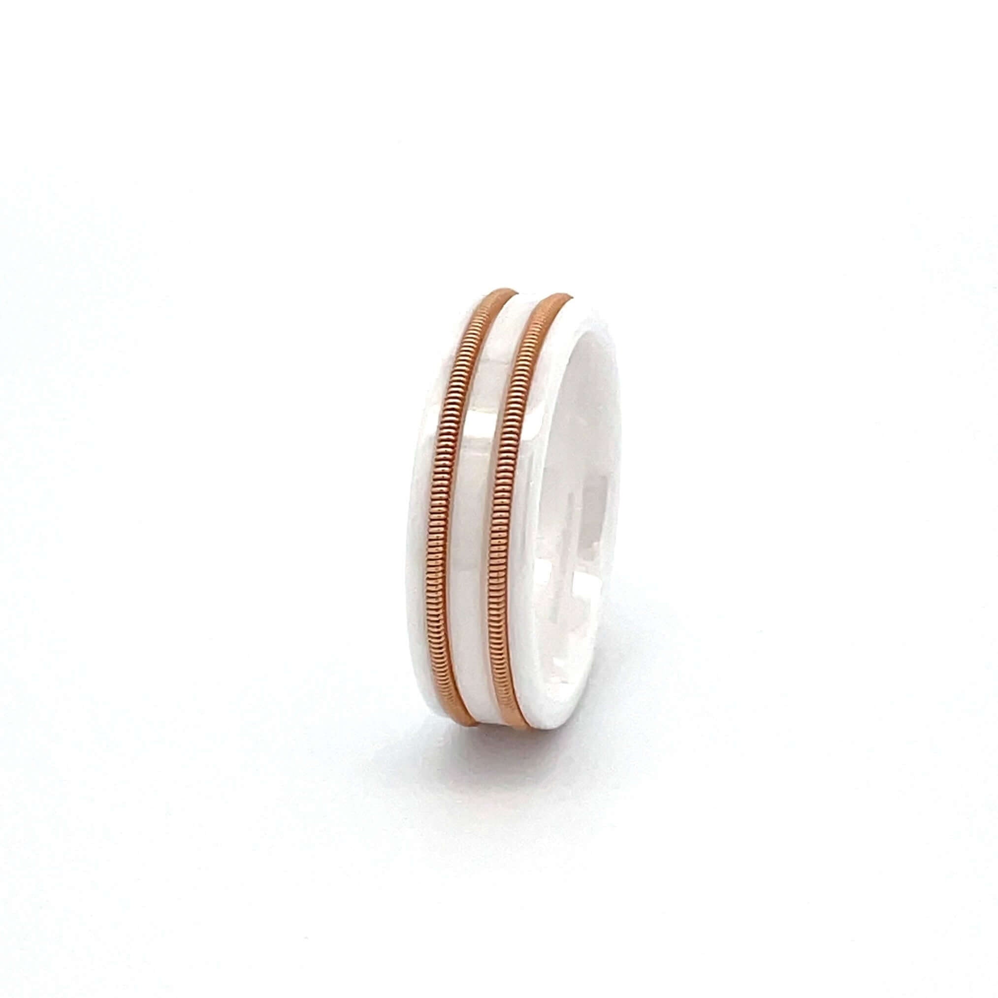 White luminous ring with embedded bronze guitar string on a white background.