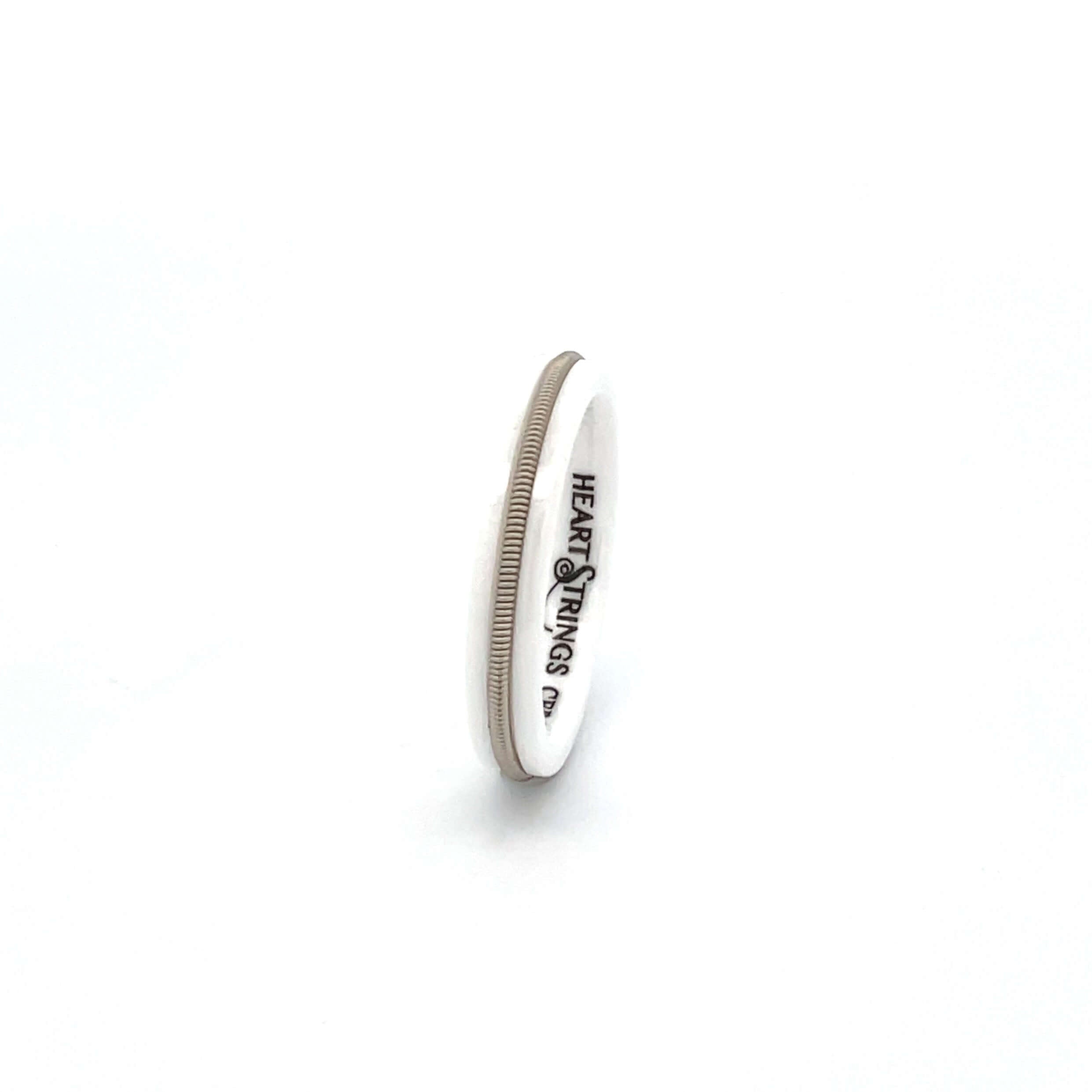 white guitar string ring on white background