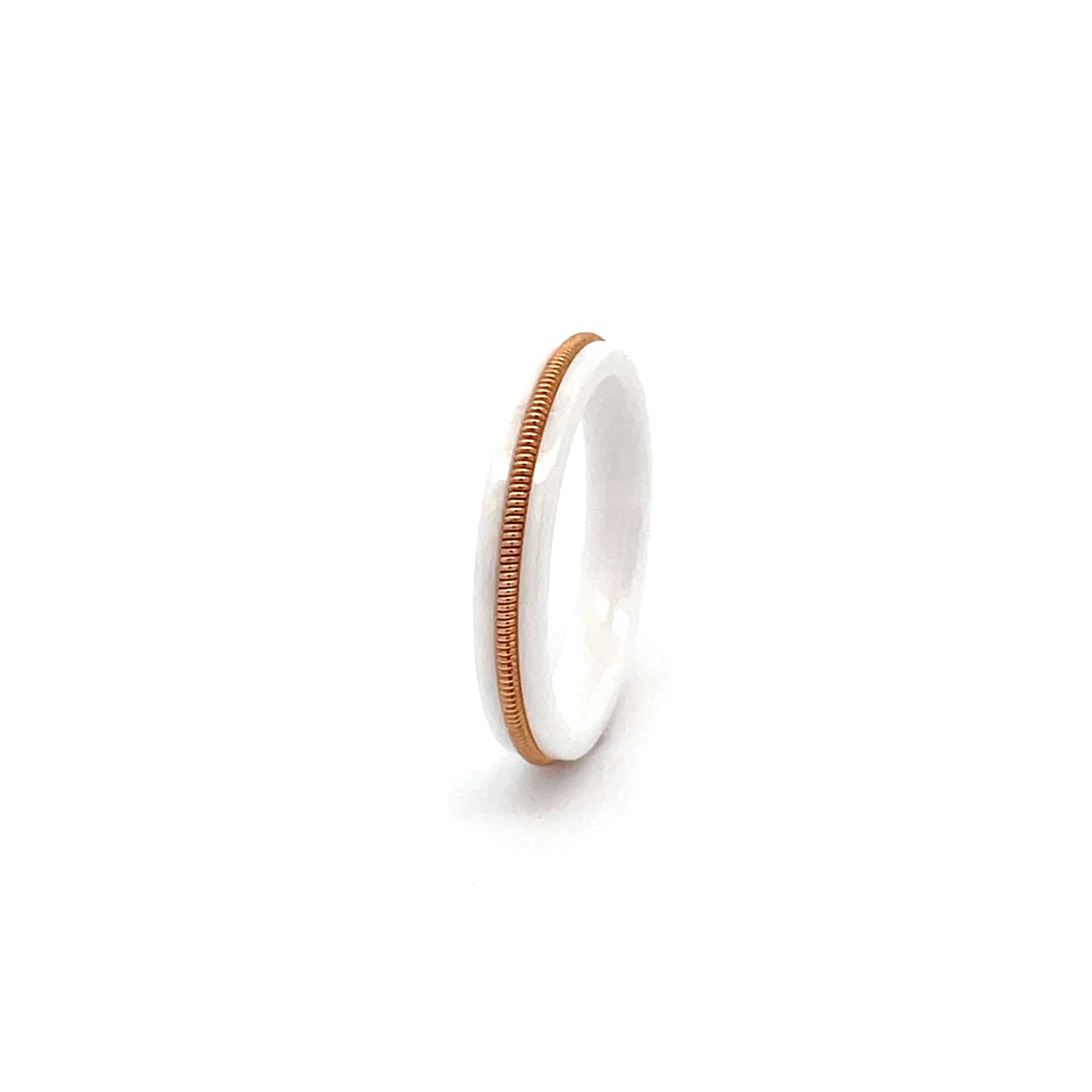 White luminous ring with embedded bronze guitar string on a white background.