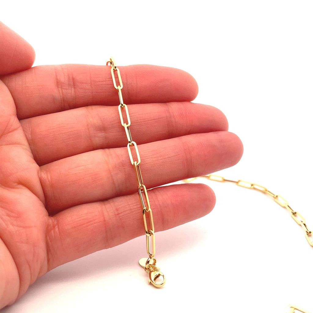 Small Brazen 14k gold paperclip chain on hand 