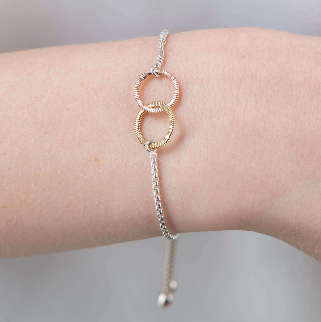 silver bracelet with interconnected circles of guitar string on model