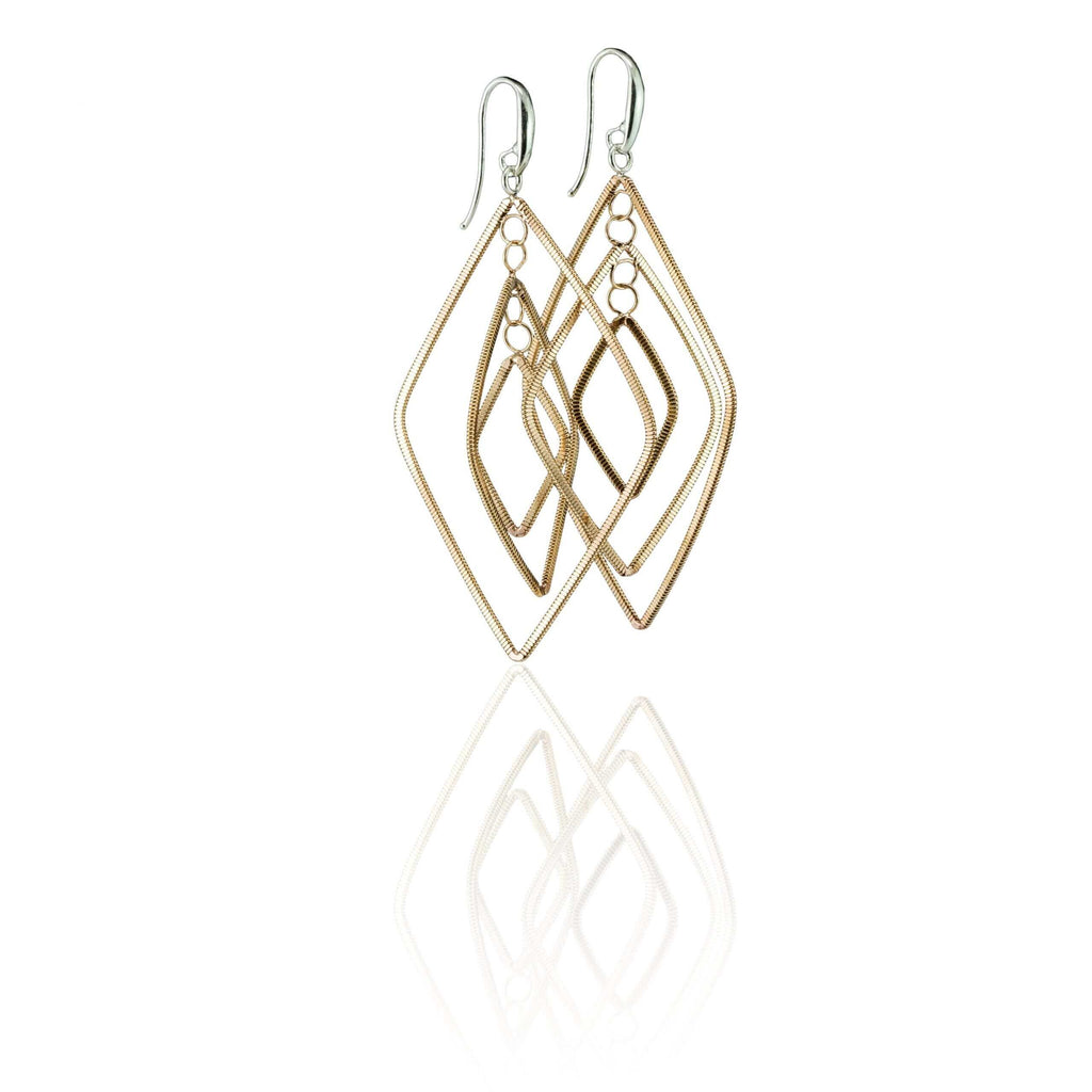 floating diamond-shaped rose gold dangle guitar string earrings on a white background