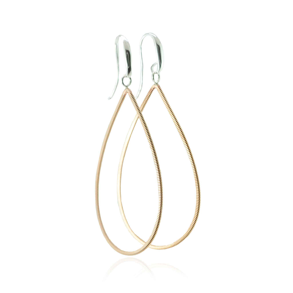 Guitar string drop earrings with silver ear hooks on white background