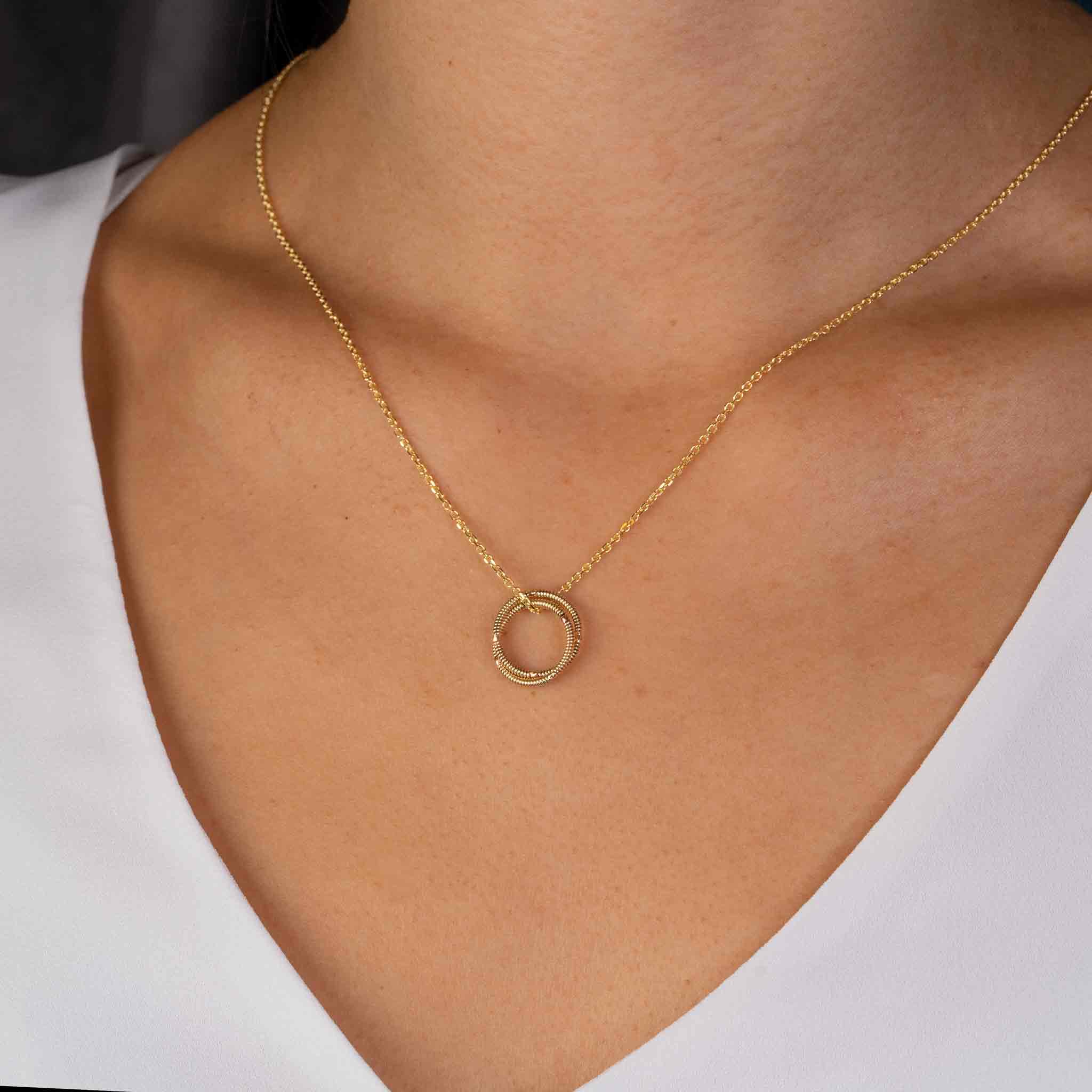 electric guitar string round pendant on 10K gold chain on model