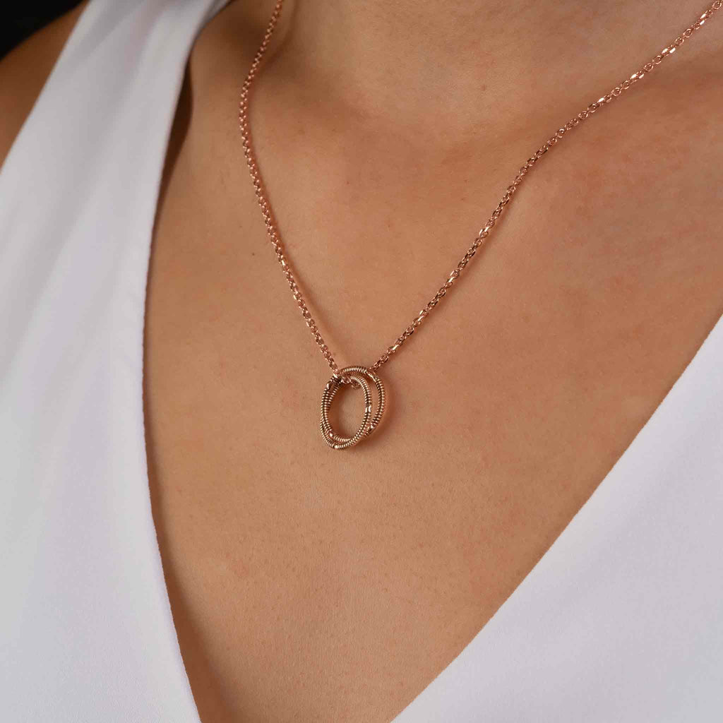 electric guitar string round pendant on solid 10K rose gold chain on model, side view