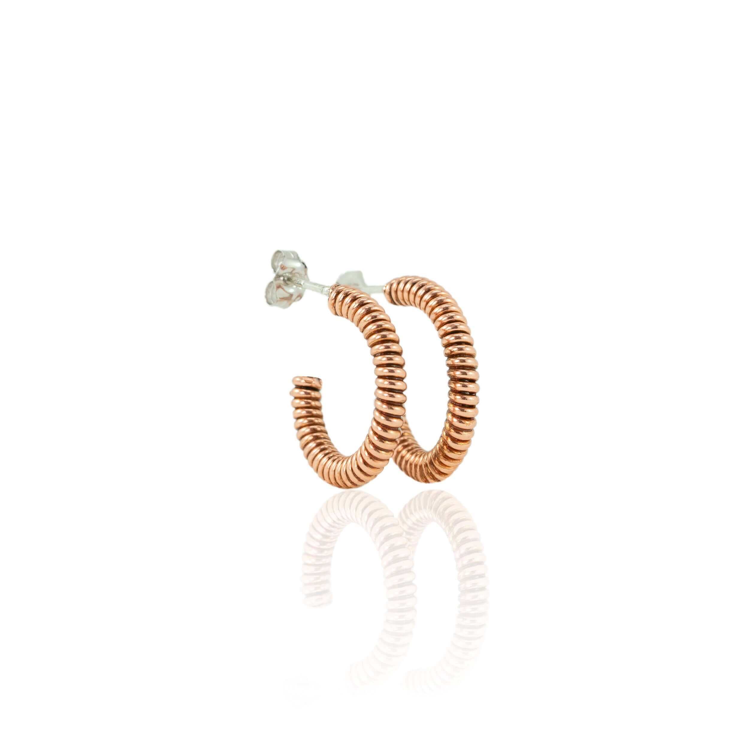 Piano string hoop earrings on a white background