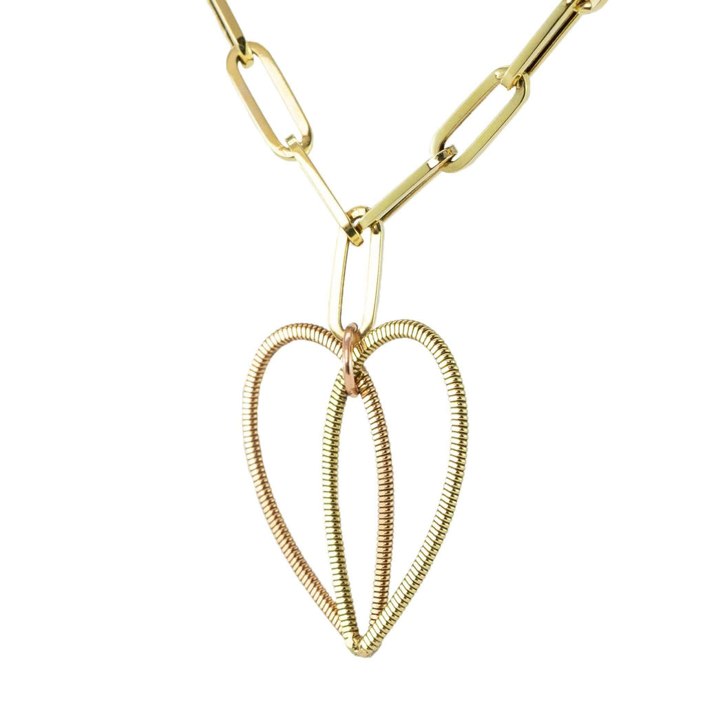 acoustic guitar string heart pendant on a 14K gold long link chain on a white background