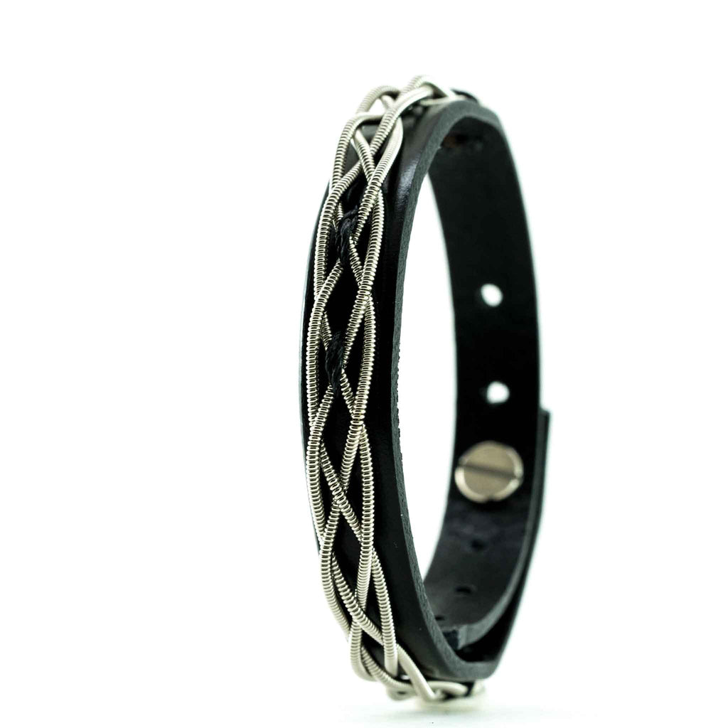 Heartstrings woven electric guitar string and black leather bracelet on a white background