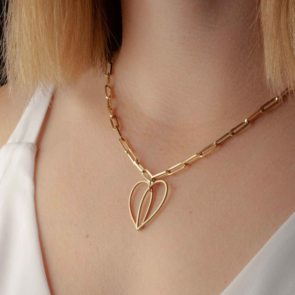 guitar string heart pendant on a large 18" 14K gold long link chain on model