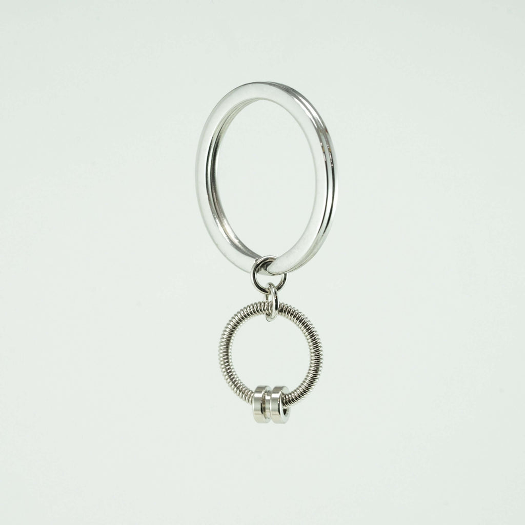 silver bass guitar string keychain on a white background