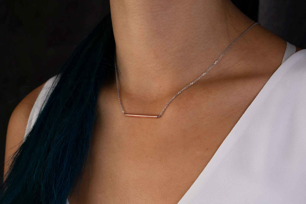 Piano string and white gold necklace on model