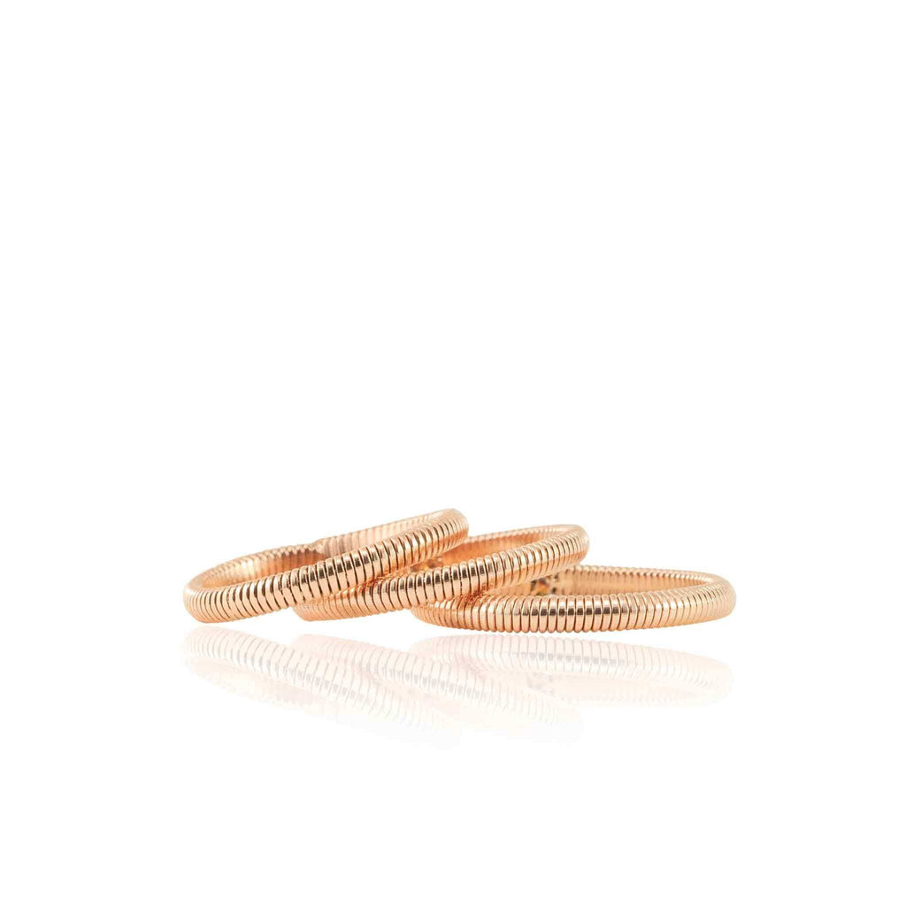 Three piano string rings on white background