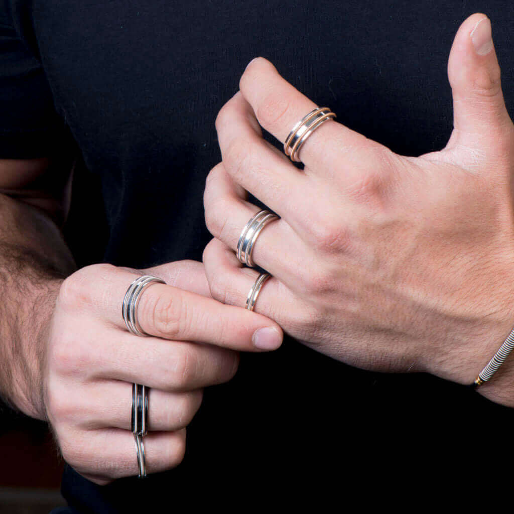 guitar string rings close-up on male model with a black shirt