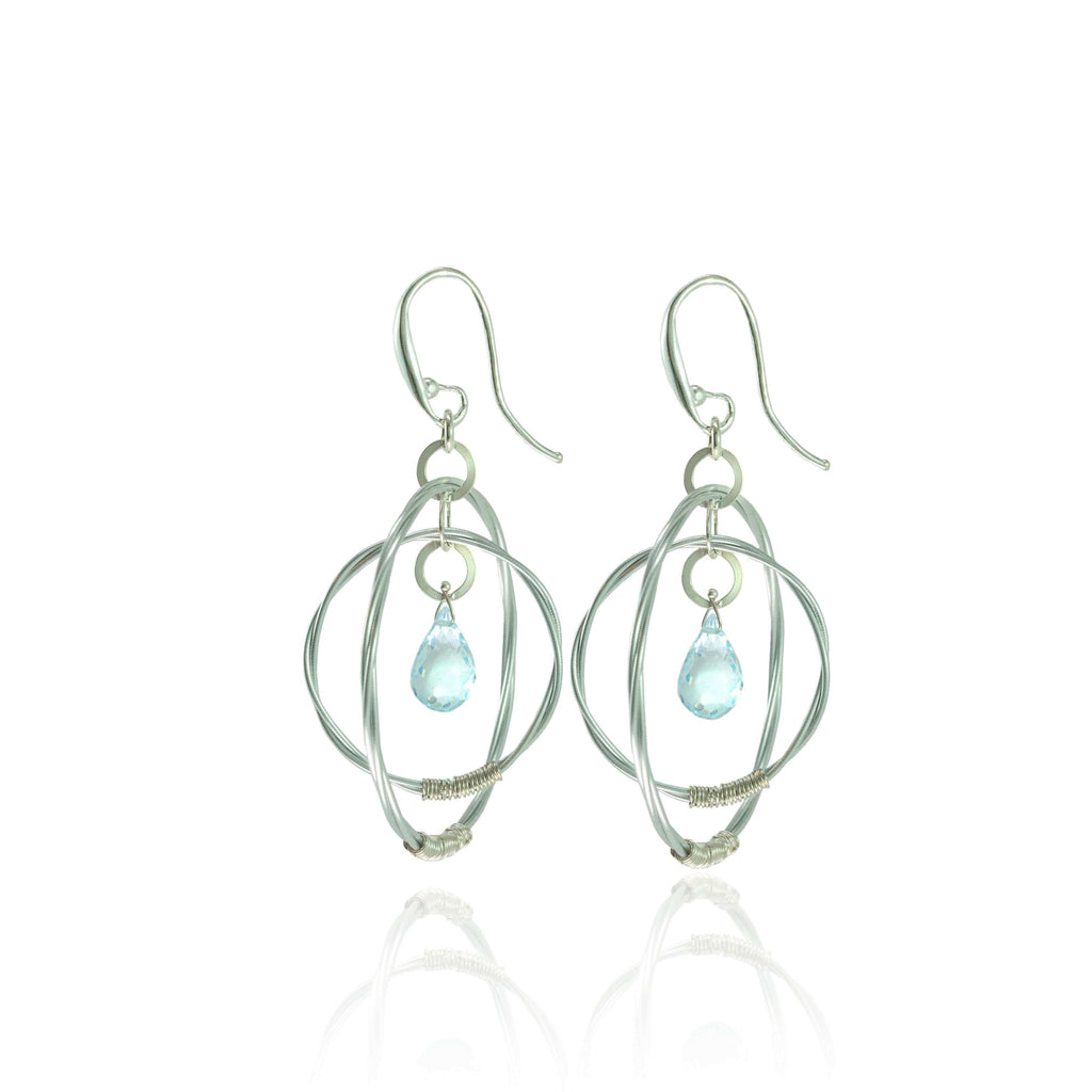 Violin string double hoop earrings with aquamarine gemstones on a white background